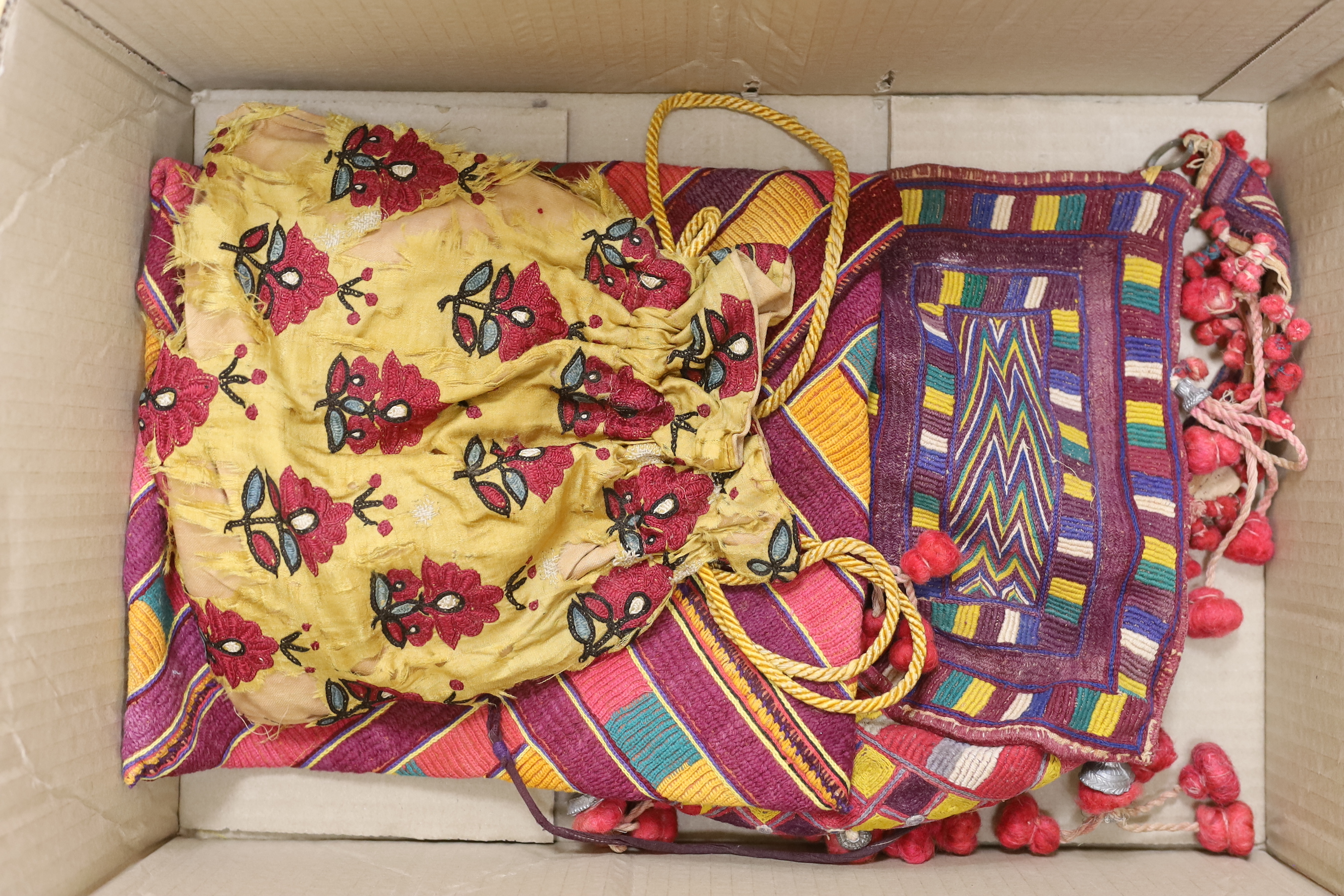 Two late 19th early 20th century Kohistani embroidered bags and a woven cushion cover/bag and a silk embroidered Banjara bag (a.f.), cushion cover 69cm wide x 31cm long